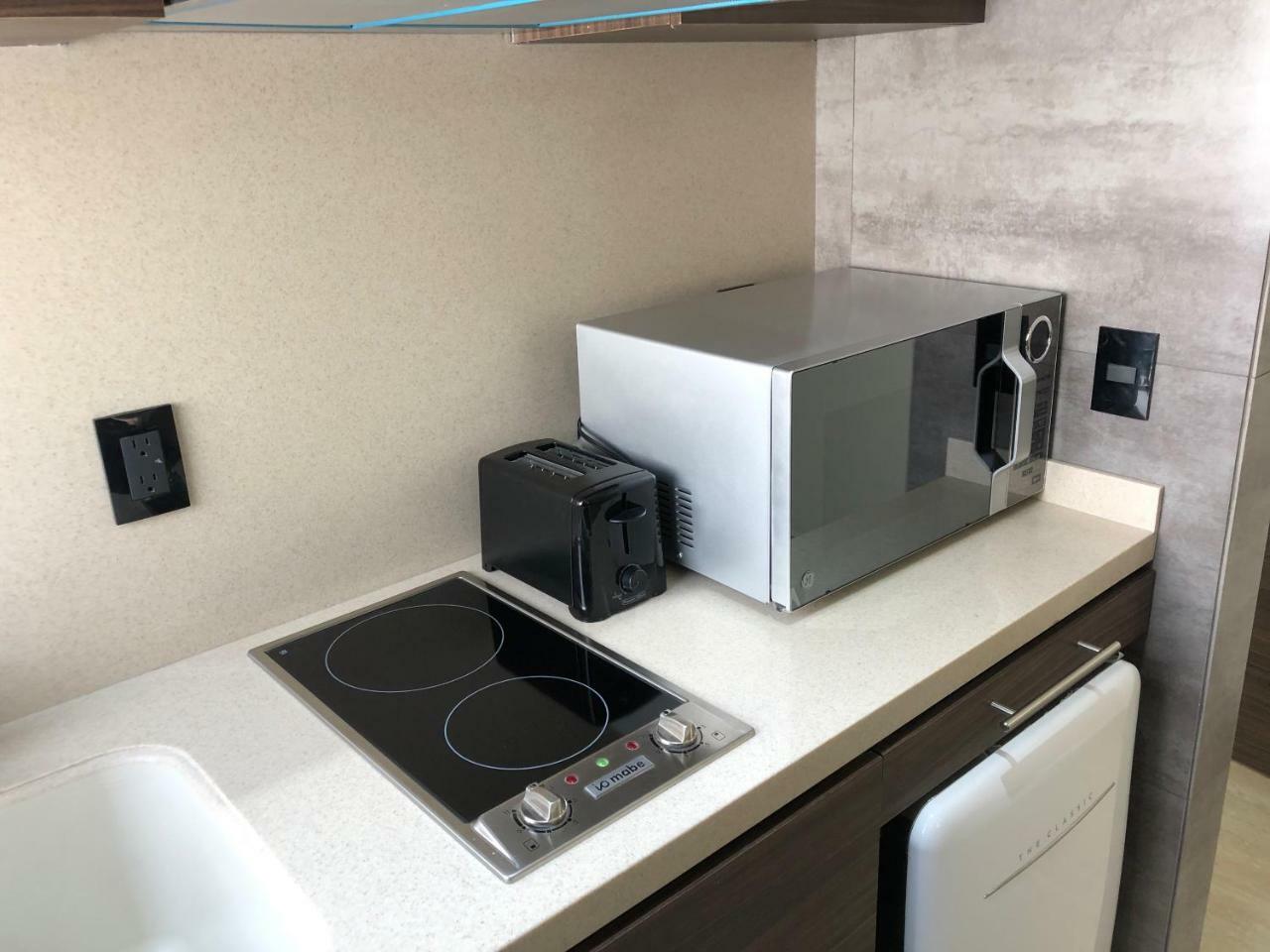 Mc Suites Mexico City Exterior photo A microwave oven in a kitchen
